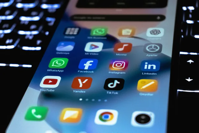 Close-up of a smartphone screen showing popular social media and utility app icons. B2B social selling 2027 trends: five signals to monitor